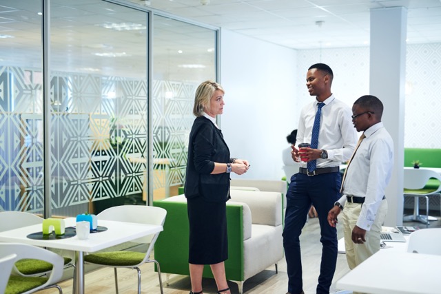 But first, business. Shot of a group of businesspeople having a discussion in an office.